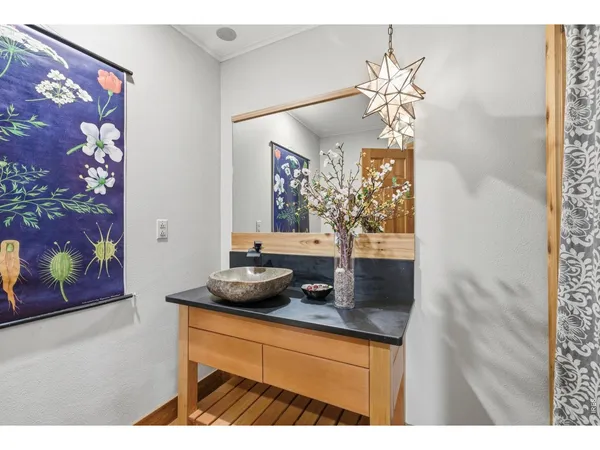 a room with a chandelier and a mirror