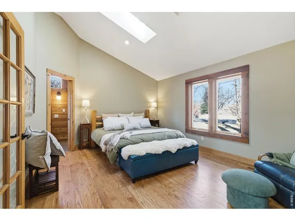 a spacious bedroom with a bed window and couch