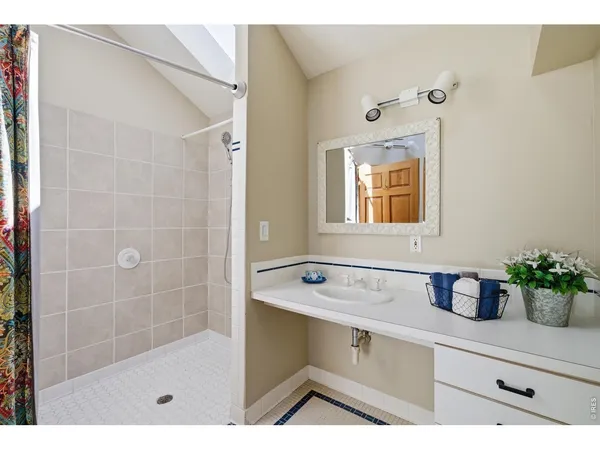 a bathroom with a bathtub sink and mirror