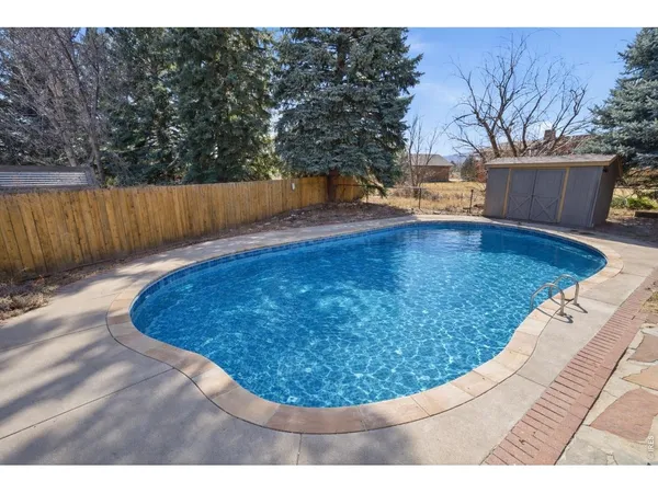 a view of a swimming pool with a yard