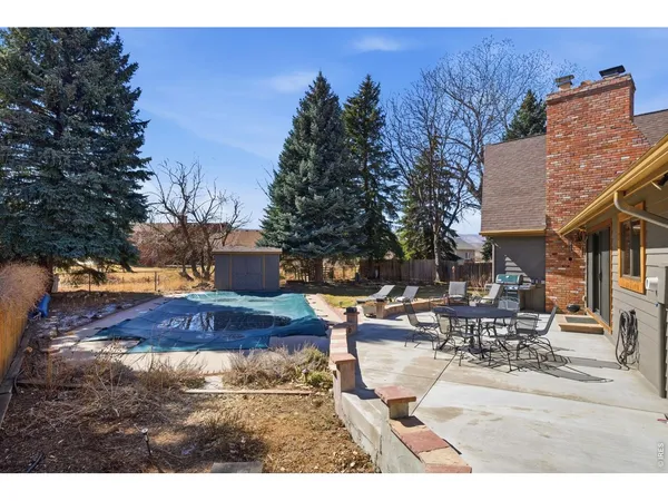 a view of a backyard with sitting area