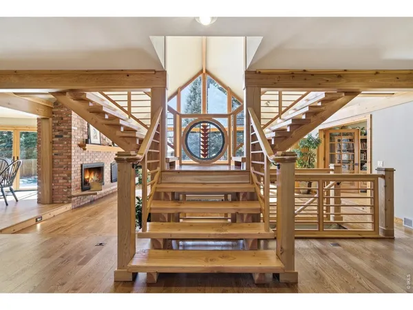 a view of a hallway with wooden floor and door