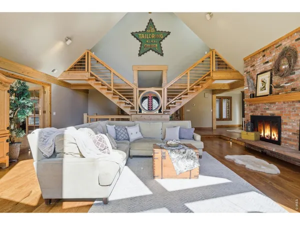 a living room with furniture a fireplace and a table