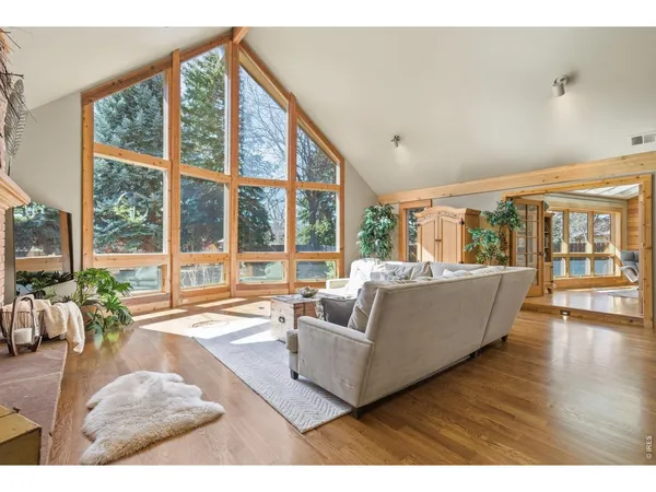 a living room with furniture and large windows