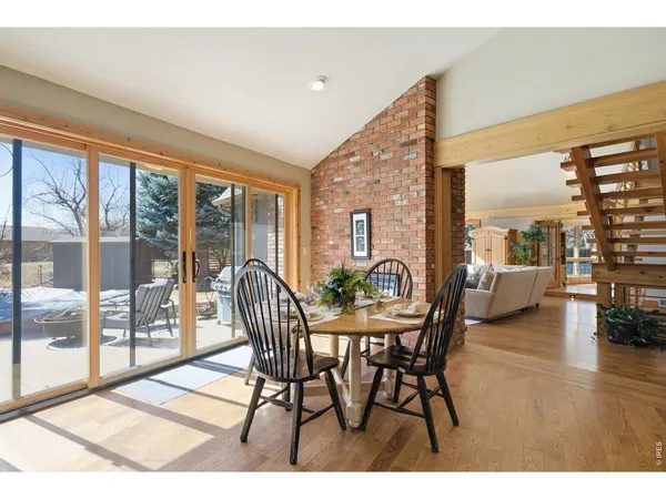 a dining room with furniture and wooden floor