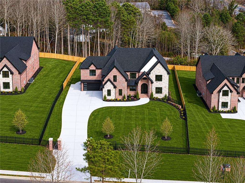 405 Thunder Road Buford, GA 30518 - Photo 1 of 104 an aerial view of a house with garden