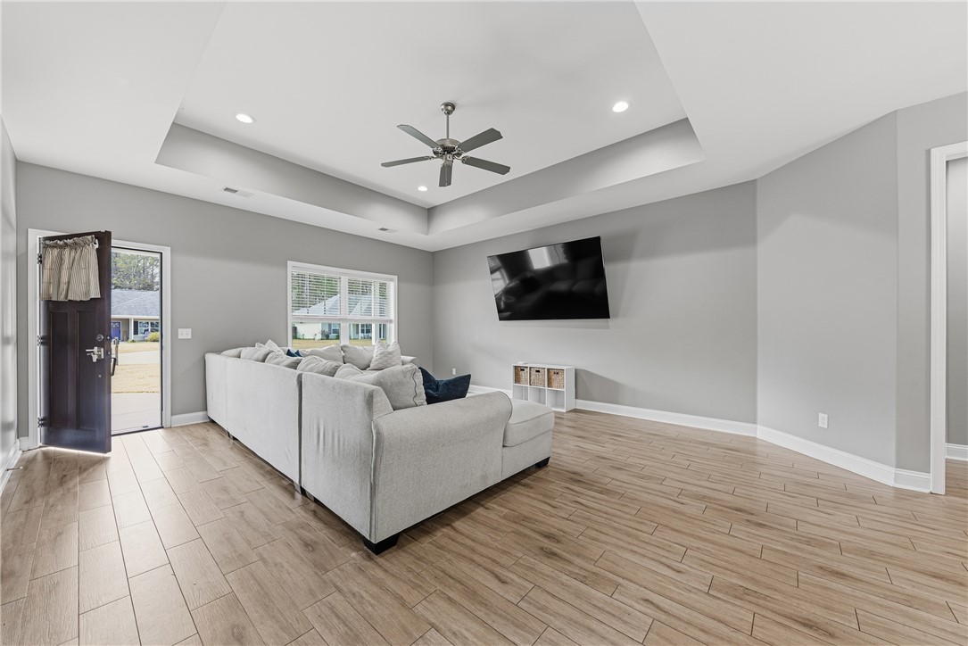 113 Logans Way Kingsland, GA 31548 - Photo 5 of 32 Living room with trey ceiling and wood look tile flooring.