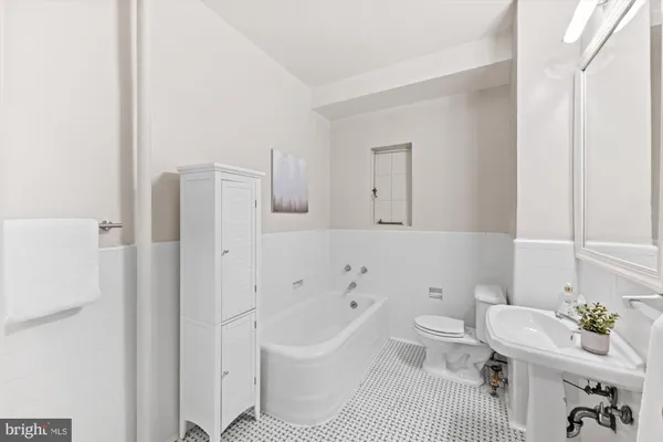 a bathroom with a sink toilet a mirror and shower