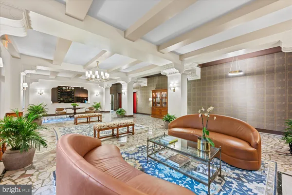 a living room with furniture a flat screen tv and a potted plant