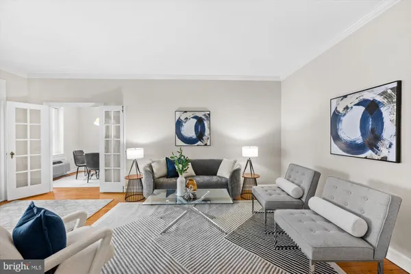 a living room with furniture a rug and a lamp