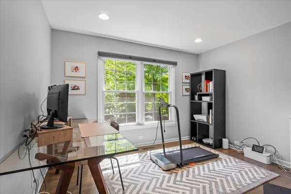 a view of a workspace with furniture and a window