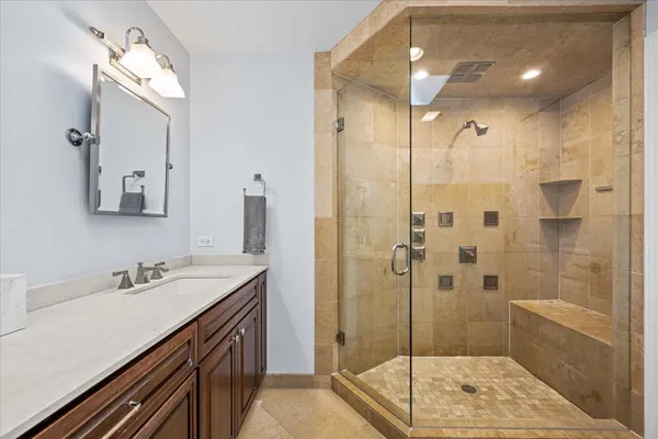 a bathroom with a shower sink and mirror