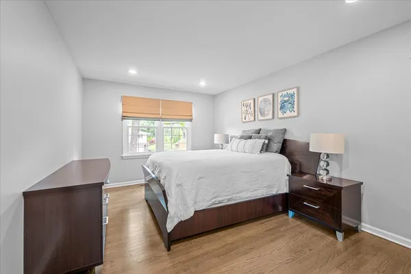 a spacious bedroom with a bed and a window