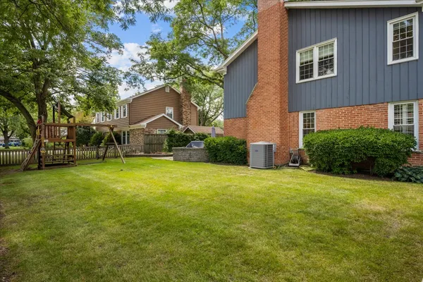 a view of a house with backyard and garden