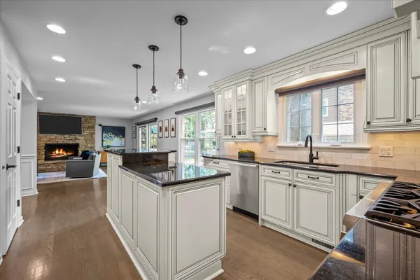 a kitchen with granite countertop a sink and cabinets