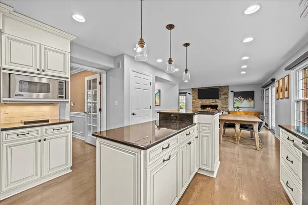 a kitchen with white cabinets and appliances