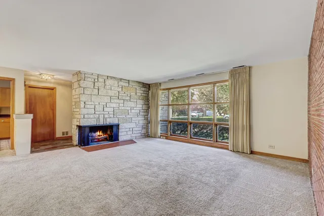 an empty room with furniture and a fireplace