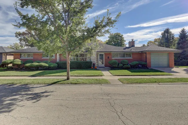 a house view with a sitting space and garden