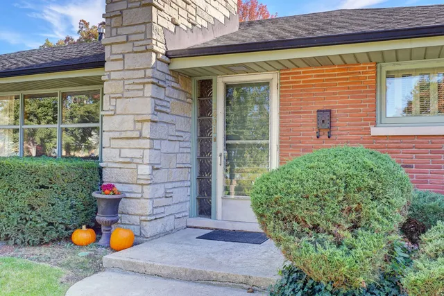 a front view of a house with a yard and fountain