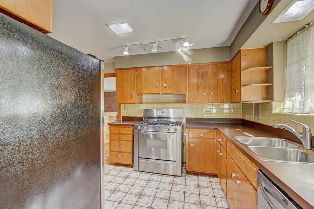 a kitchen with a stove a sink and a refrigerator