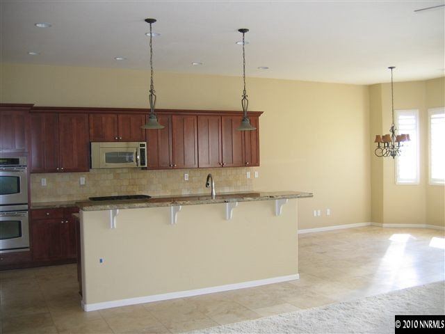 1598 Gemtown Court Reno, NV 89521 - Photo 5 of 5 a kitchen with stainless steel appliances granite countertop a sink a refrigerator a sink a stove and a wooden floors