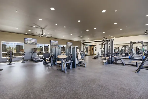 a view of a room with gym equipment and a large window