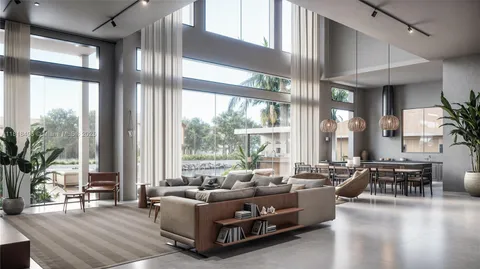 a living room with furniture and large windows