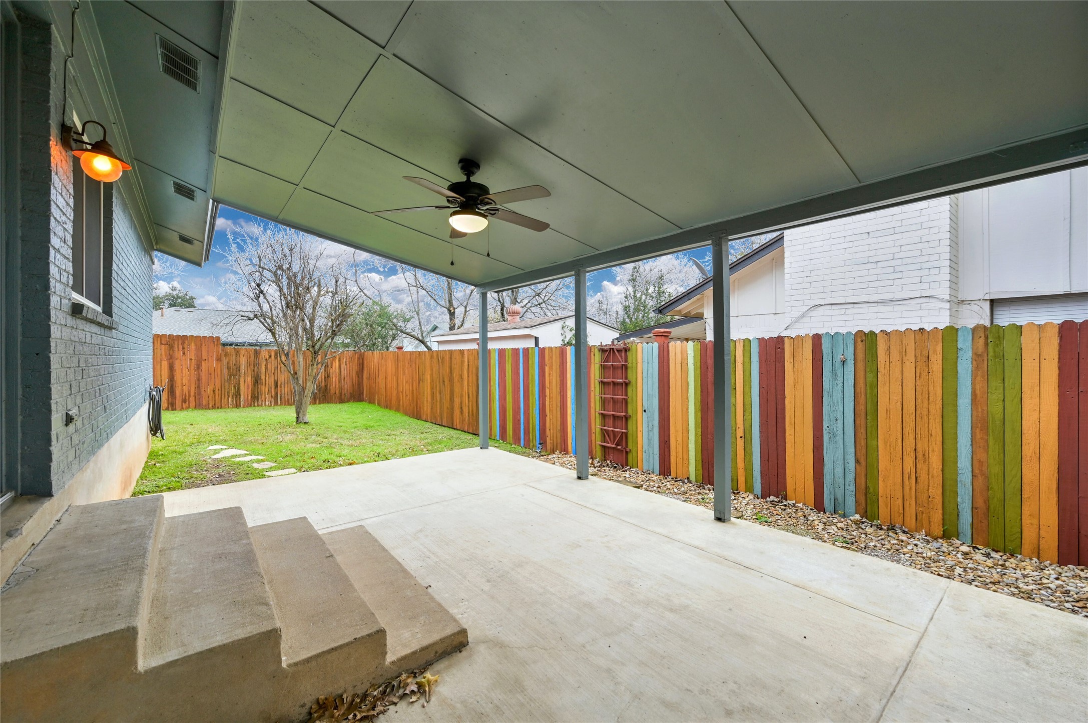 4808 Wind River Road Austin, TX 78759 - Photo 19 of 21 A spacious covered concrete patio overlooks a fenced grassy backyard.