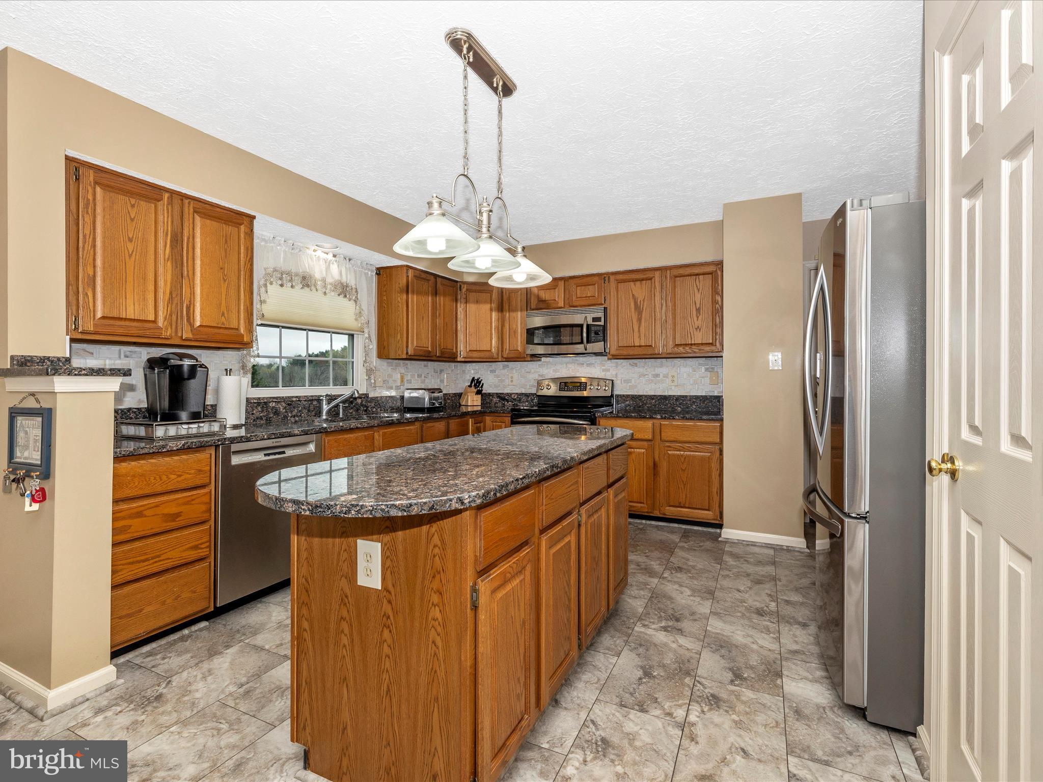 10 Knoll Side Lane Middletown, MD 21769 - Photo 14 of 84 a kitchen with stainless steel appliances granite countertop a stove a sink dishwasher and a refrigerator