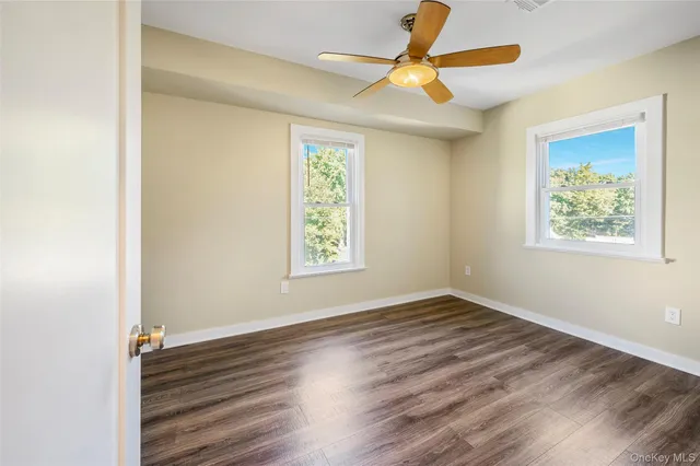 a spacious bedroom with a bed and a window