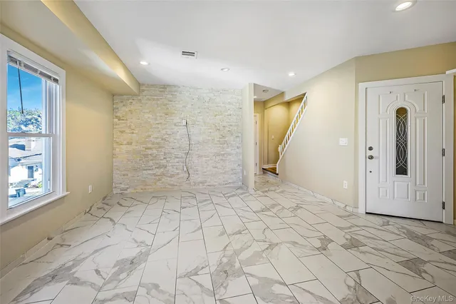 a kitchen with white cabinets a refrigerator and a stove