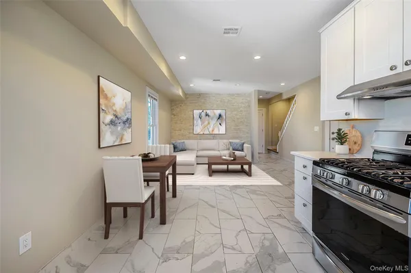 a kitchen with a refrigerator and a stove