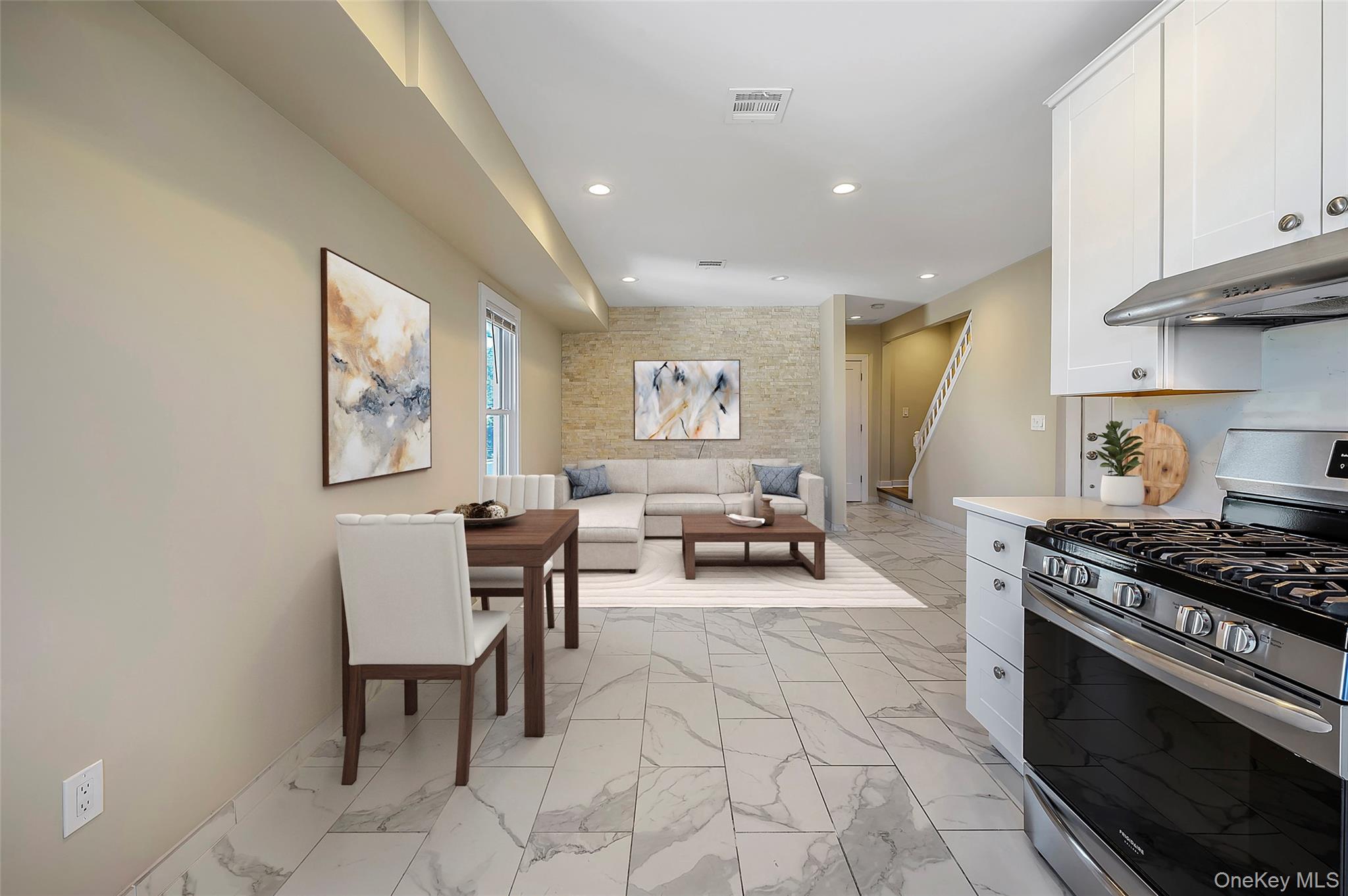 9 Todd Place, Unit 2ND FL RIGHT SIDE Ossining, NY 10562 - Photo 9 of 20 Kitchen with stainless steel range with gas cooktop, white cabinets, recessed lighting, light marble finish floors, and exhaust hood