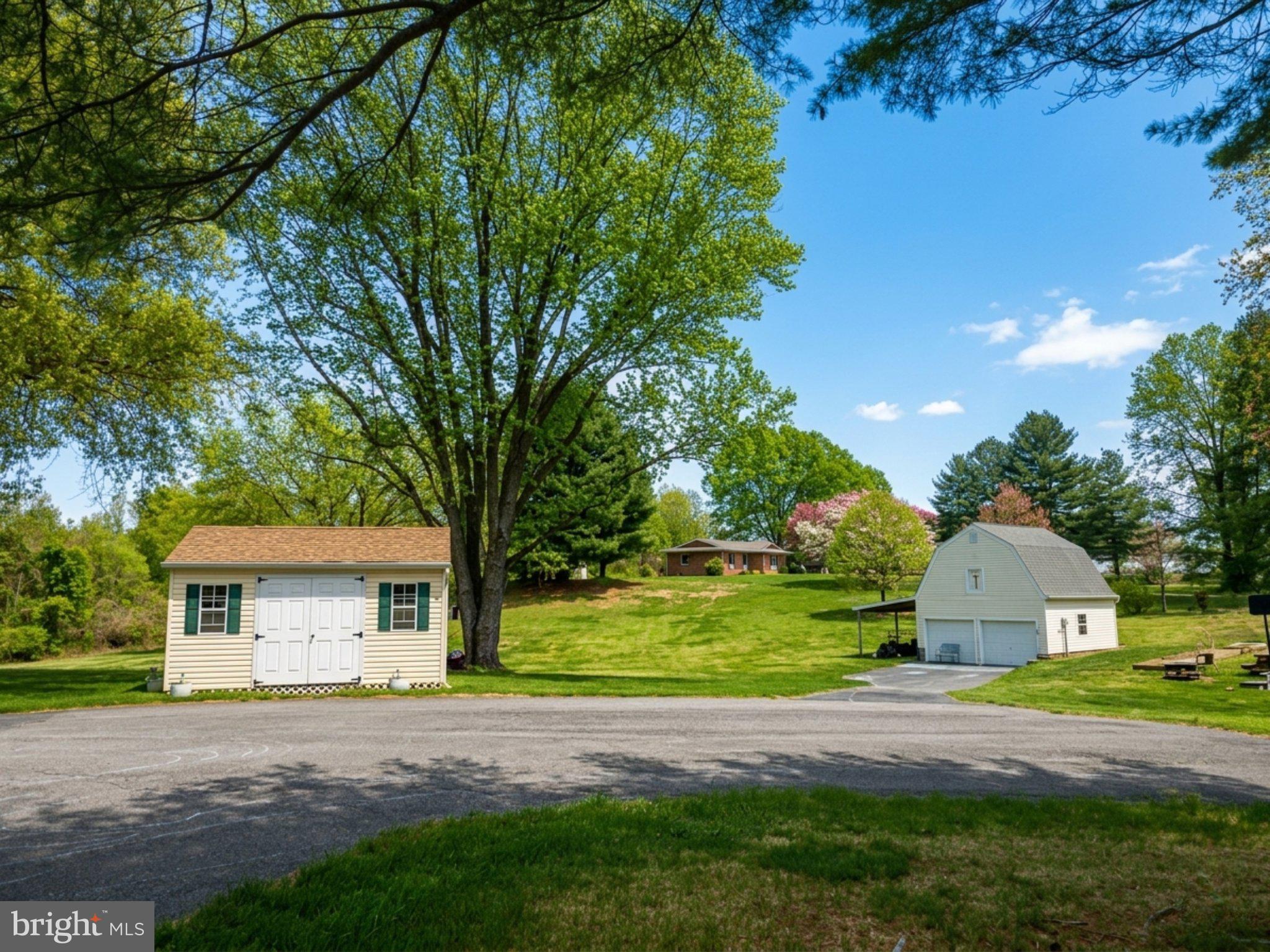8531 Solomons Island Road North Owings, MD 20736 - Photo 3 of 12 a front view of a house with a yard and trees