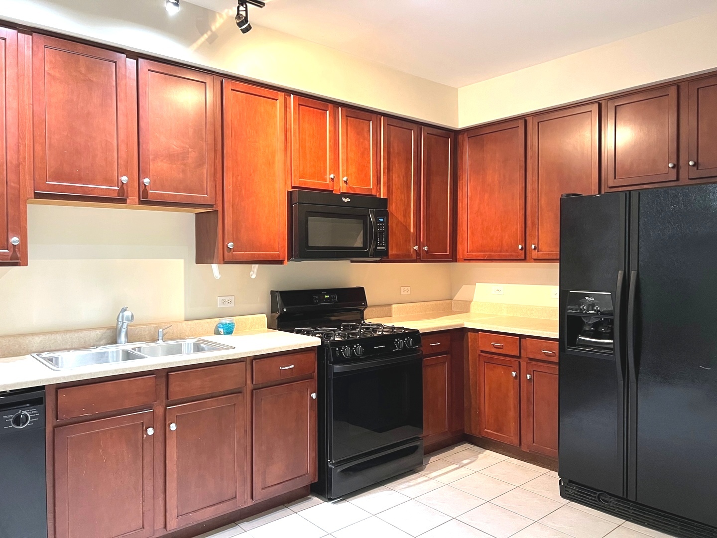 2966 White Thorn Circle Naperville, IL 60564 - Photo 4 of 14 a kitchen with a refrigerator sink and cabinets