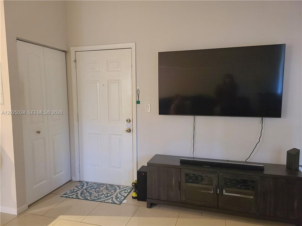 631 Lyons Road, Unit 12205 Coconut Creek, FL 33063 - Photo 5 of 14 a living room with a flat screen tv