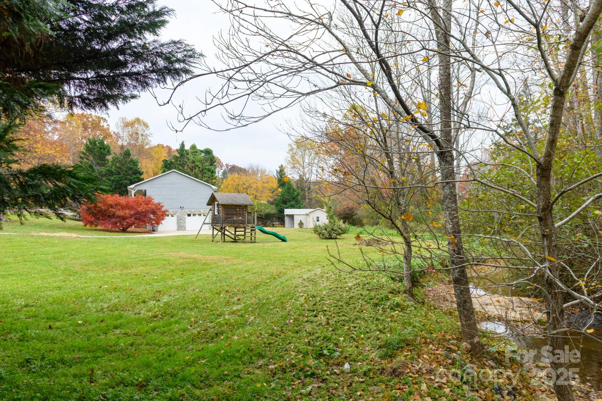 2830 Ellerwood Road Hudson, NC 28638 - Photo 22 of 46 a backyard of a house with table and chairs