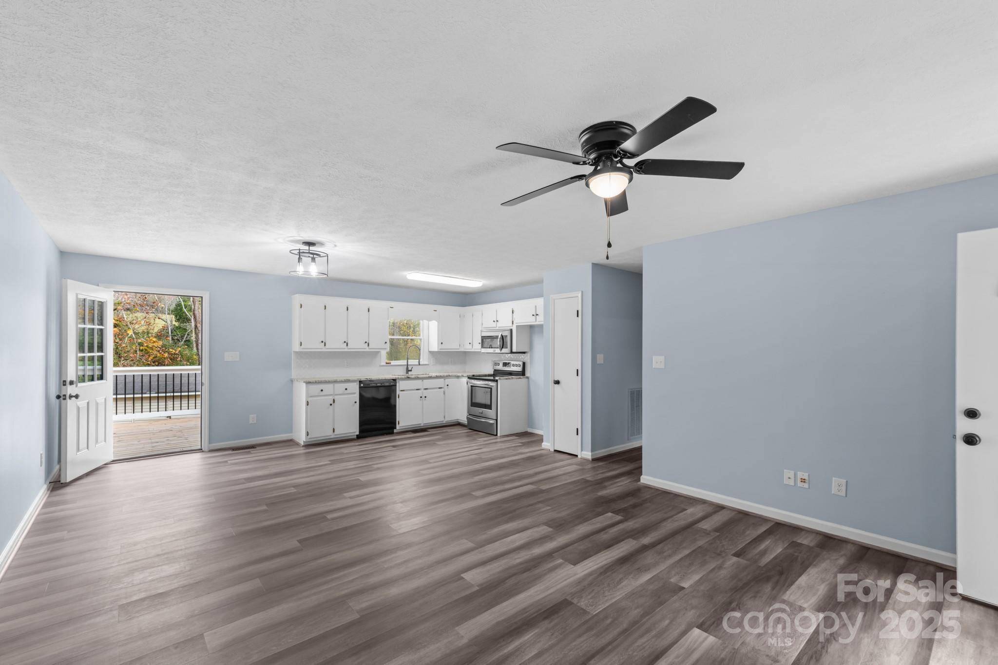 2830 Ellerwood Road Hudson, NC 28638 - Photo 29 of 46 a view of a kitchen with wooden floor and a ceiling fan
