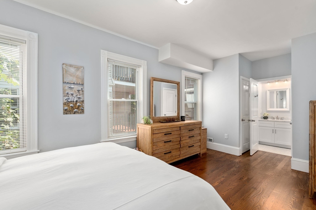 103 Dix Street, Unit 2 Boston, MA 02122 - Photo 12 of 23 a bedroom with a bed and wooden floor