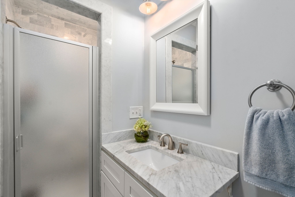103 Dix Street, Unit 2 Boston, MA 02122 - Photo 13 of 23 a bathroom with a granite countertop sink and a mirror