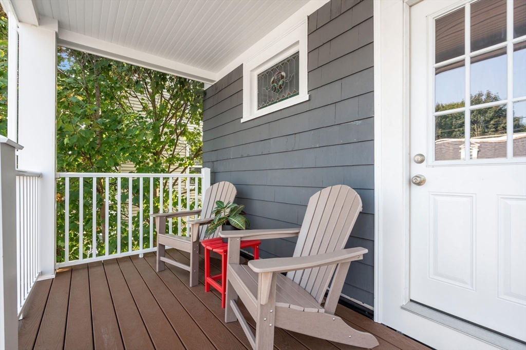 103 Dix Street, Unit 2 Boston, MA 02122 - Photo 18 of 23 a balcony view with a large window and wooden floor