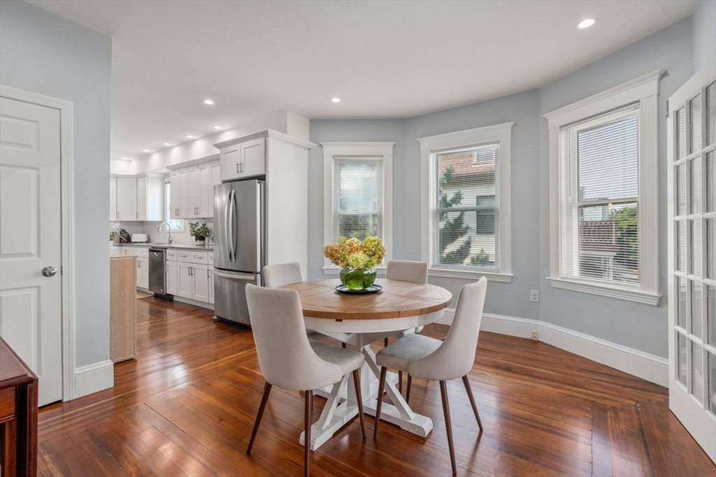 103 Dix Street, Unit 2 Boston, MA 02122 - Photo 2 of 23 a dining room with furniture and wooden floor