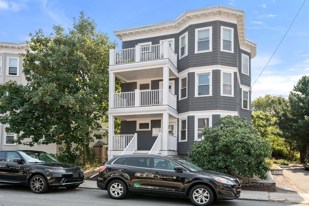 103 Dix Street, Unit 2 Boston, MA 02122 - Photo 21 of 23 a car parked in front of a big house