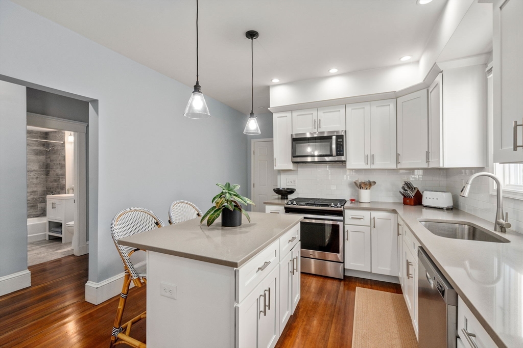 103 Dix Street, Unit 2 Boston, MA 02122 - Photo 7 of 23 a kitchen with a sink a counter space appliances and cabinets