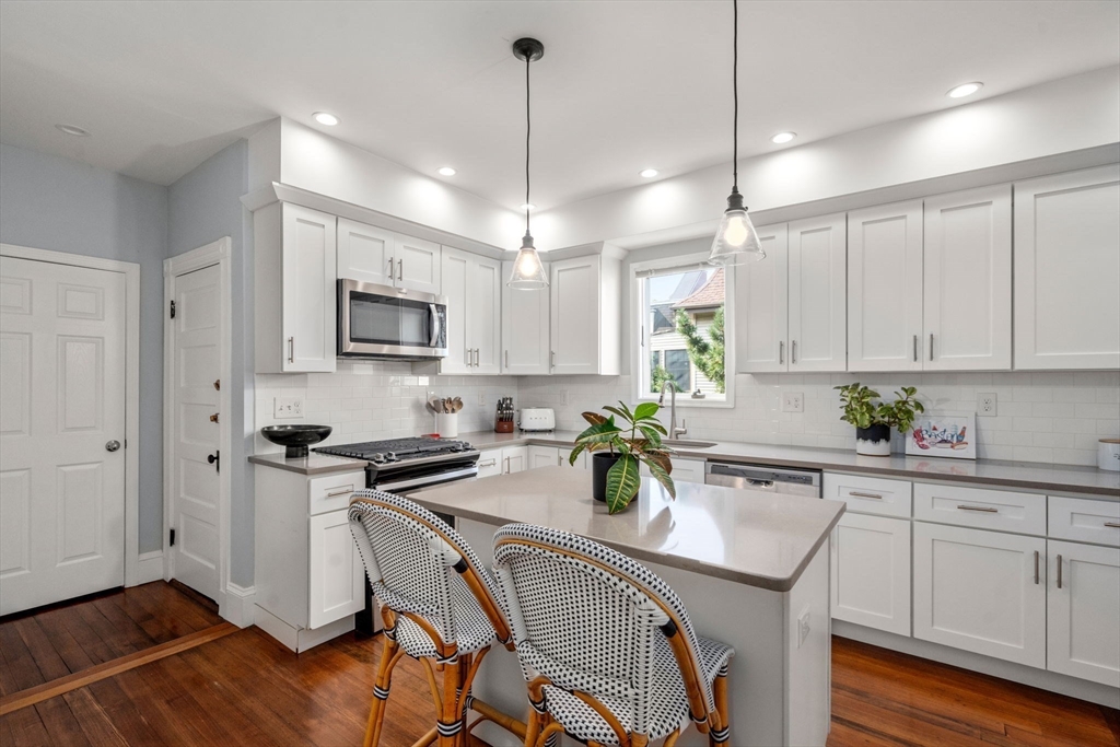 103 Dix Street, Unit 2 Boston, MA 02122 - Photo 8 of 23 a kitchen with a sink a counter space appliances and cabinets