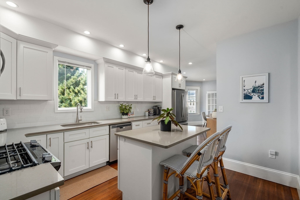 103 Dix Street, Unit 2 Boston, MA 02122 - Photo 9 of 23 a kitchen with a table chairs stove and cabinets