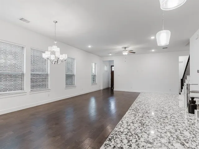 a view of a livingroom with a ceiling fan and window