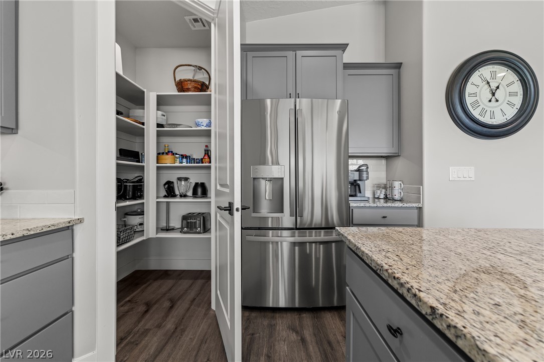 1436 Manassas Ridge Mesquite, NV 89027 - Photo 33 of 77 A well-organized pantry complements the sleek stainless steel refrigerator and granite countertops in this culinary space.