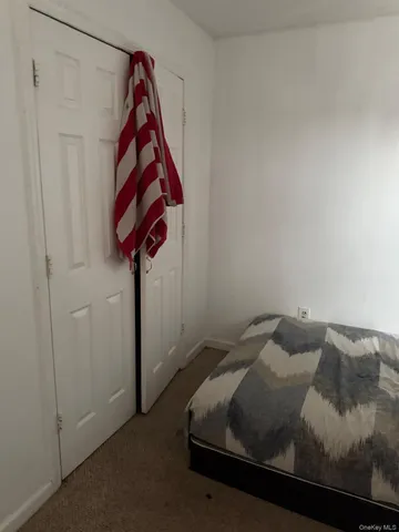 a bedroom with a bed and a curtain