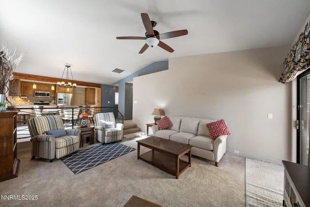 a living room with furniture and a ceiling fan